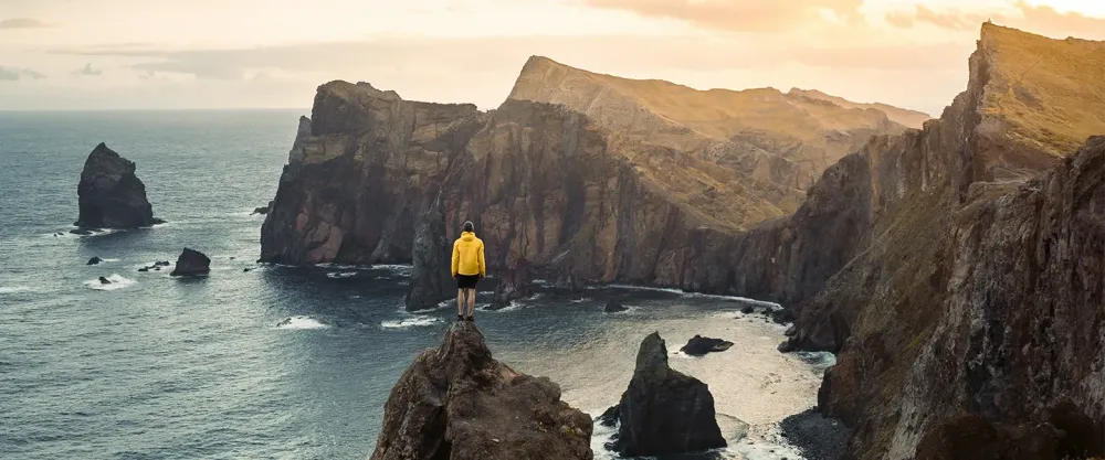 Hikers overlooking cliffs and ocean
